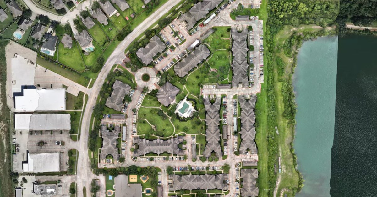 An orthomosaic of an apartment complex beside a lake, open on an interactive map in DataDelivery